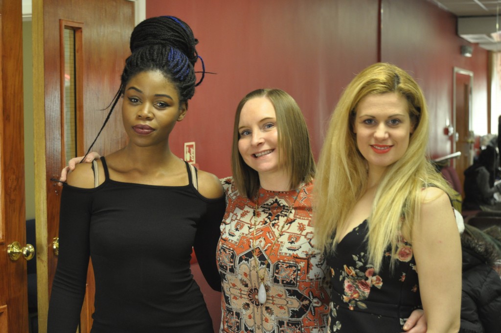 Above: Encore Films Choir members (1st and 3rd from left) JOYCE AGBONSON and LAIA MARTINEZ RUBIR with choir vocal coach, organist and production assistant NATALIE ANNE OWEN